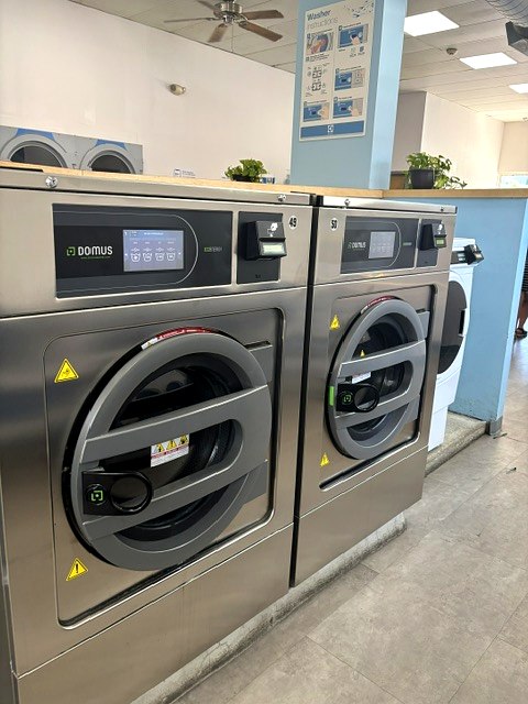 Large stainless high-capacity front-load machines at Scrubs Laundry in Chelsea